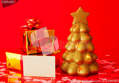 Image of Two presents, blank card and golden evergreen tree