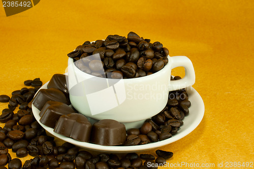Image of Cup full with coffee beans and chocolate candies