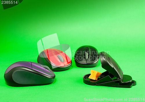 Image of Three computer mouses with a mousetrap 