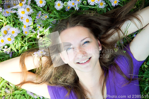 Image of Teen girl laying in grass