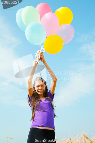 Image of Teen girl at a wheat field with balloons