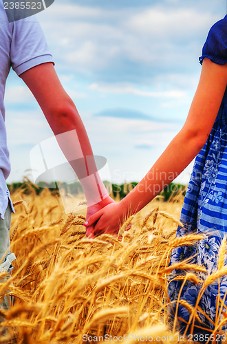 Image of Young couple holding hands