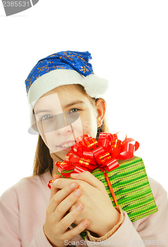 Image of Teen girl wearing Santa hat with a present against white backgro