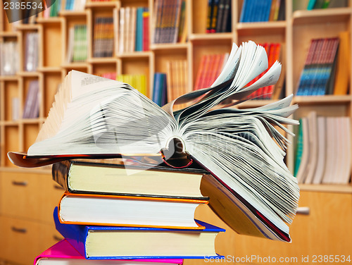 Image of Open book on a stack of books