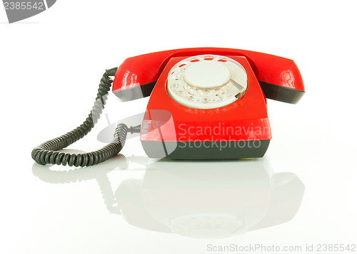 Image of Red old fashioned telephone against white background