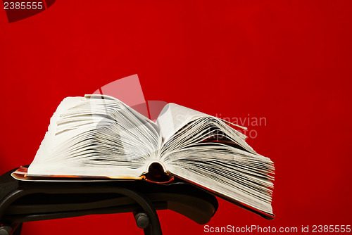 Image of Open book laying on the chair