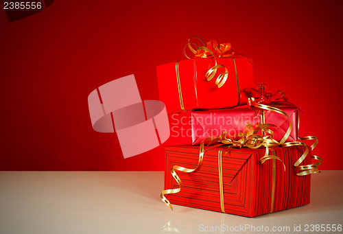 Image of Christmas gifts over red background