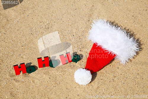 Image of Wooden word 'Ho! Ho! Ho!' with Santa's hat