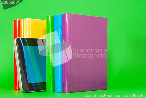 Image of Row of colorful books and tablet PC