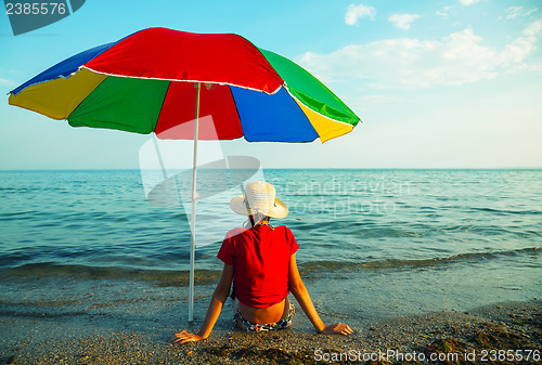 Image of Teen girl seating at a beach