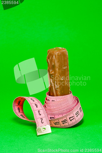 Image of Chocolate bar with a pink metering tape