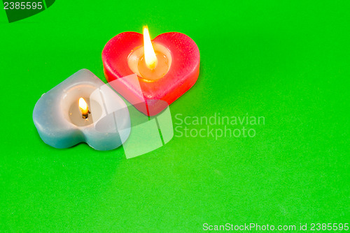 Image of Two burning heart shaped candles