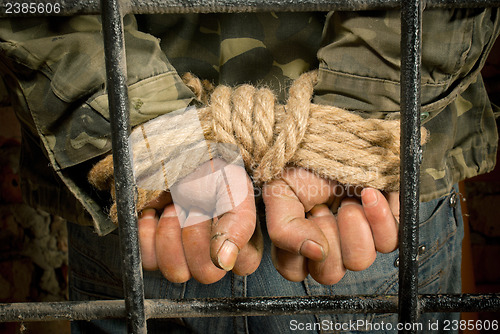 Image of Man with hands tied up with rope