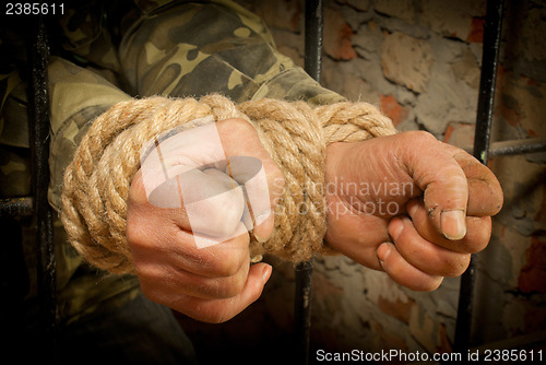 Image of Man with hands tied with rope