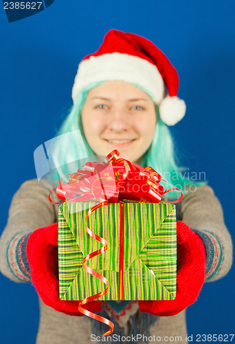 Image of Teen girl holds a Christmas present