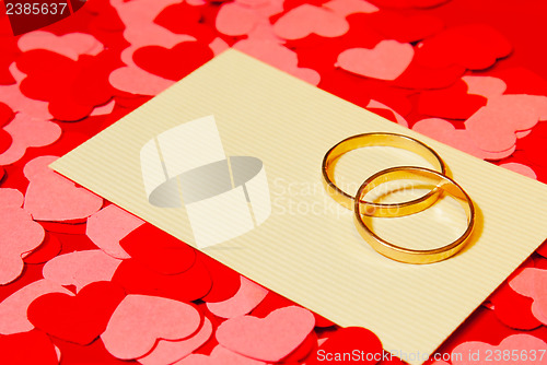 Image of Two rings and a card with marriage proposal