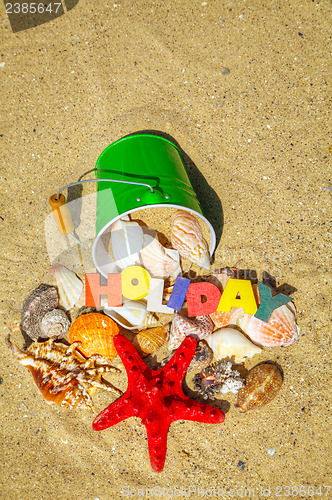 Image of Wooden colorful word 'Holiday' on the sand