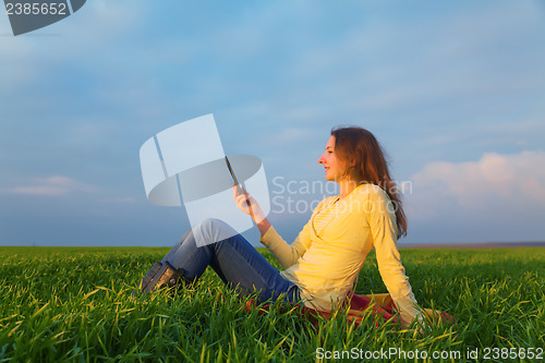 Image of Teen girl reading electronic book