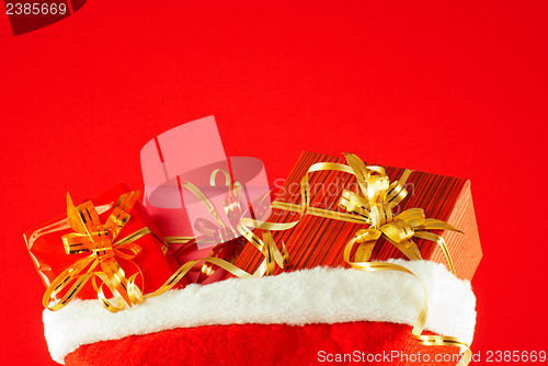 Image of Christmas presents in the bag against red background