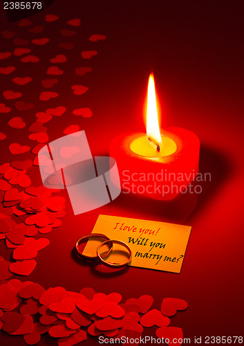 Image of Two rings and a card with marriage proposal