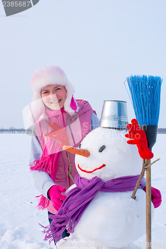 Image of Teenage girl with snowman