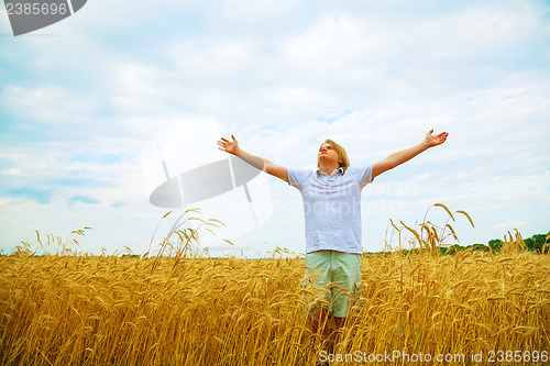 Image of Young man staying with raised hands