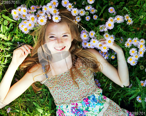 Image of Teen girl lying in grass