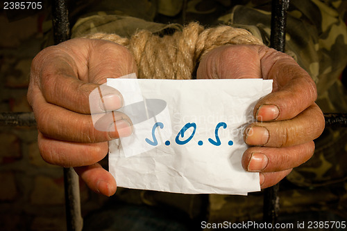 Image of Man with hands tied up with rope