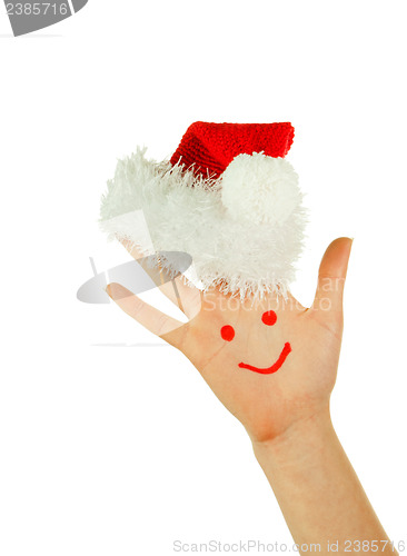 Image of Human's palm with smile on it wearing Santa's hat