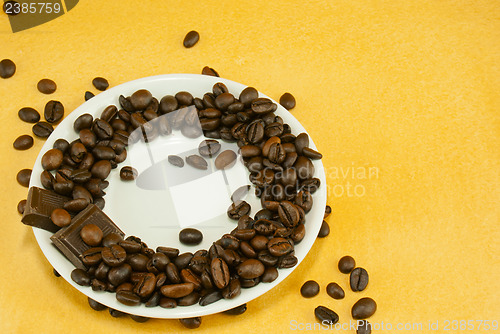 Image of Saucer with coffee beans and chocolate bars