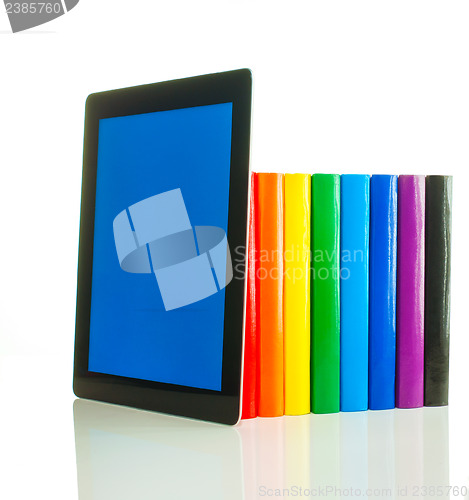 Image of Row of colorful books and tablet PC