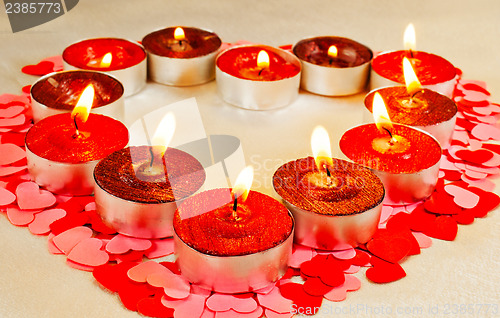 Image of Many burning candles in a form of heart  