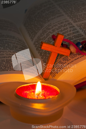 Image of Open Bible with cross and burning candles