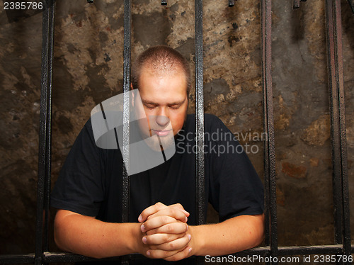 Image of Young man behind the bars