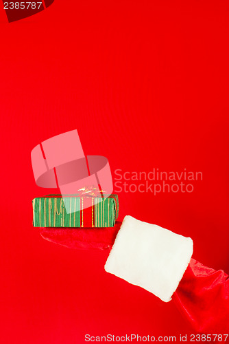 Image of Santa's hand holding a Christmas present