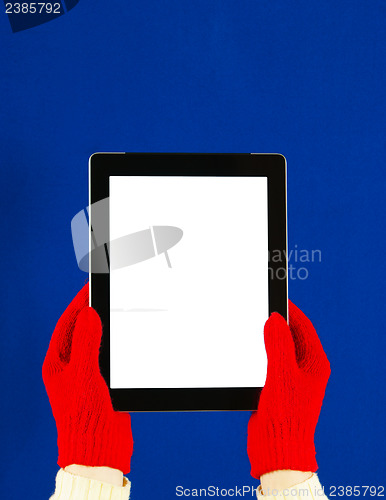 Image of Hands wearing red gloves holding a tablet PC