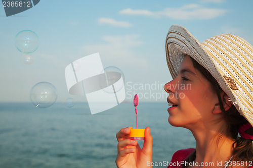 Image of Teen girl blowing bubbles