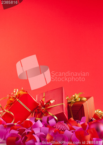 Image of Christmas gifts over red background