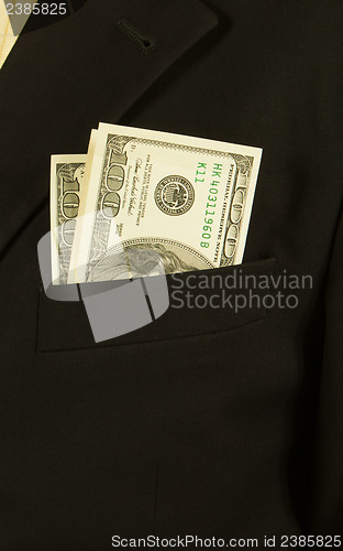 Image of Close-up of businessman with dollar banknotes in pocket