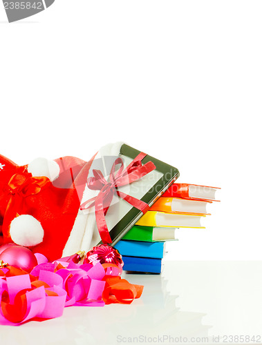 Image of Electronic book reader with stack of books in bag against white background