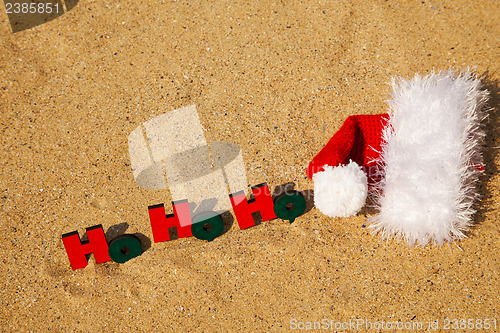 Image of Wooden word 'Ho! Ho! Ho!' with Santa's hat