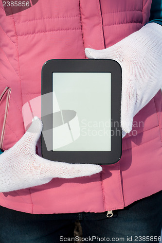 Image of Woman's hands holding e-book reader
