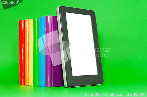 Image of Row of colorful books and tablet PC