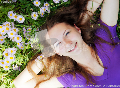 Image of Teen girl lying in grass