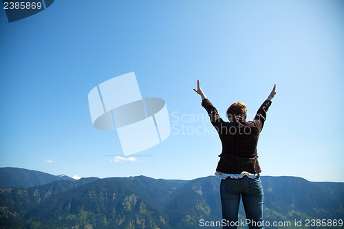 Image of Woman with raised hands
