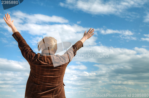 Image of Woman with raised hands
