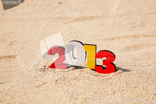 Image of Wooden 2013 year number on the sand