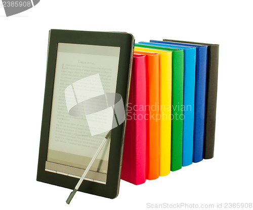 Image of E-book reader with stack of printed books