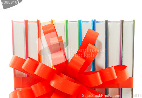 Image of Row of colorful books tied up with ribbon