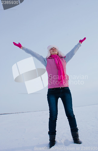 Image of Teen girl staying with raised hands